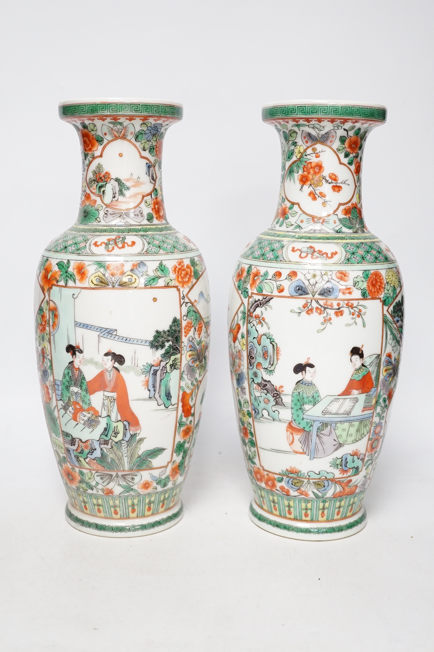 A pair of 20th century Chinese famille verte vases and a figure, tallest 31cm